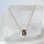 Smoky quartz teardrop necklace in 14k gold-filled on a crystal block