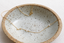 Gold-filled cubic zirconia station necklace with spring ring clasp in a speckled bowl