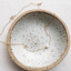 Gold-filled freshwater pearl necklace with spring ring clasp in a speckled ceramic dish