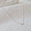 Sterling silver faceted aquamarine bead necklace on textured white linen