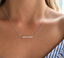 Sterling silver opal beaded bar necklace worn at the collarbone