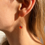 Carnelian threader earring glowing in sunlight
