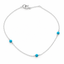 Turquoise station necklace in sterling silver with three genuine turquoise beads hand wire-wrapped along a dainty cable chain, on a white background