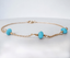 Side view of a 14k gold-filled turquoise station bracelet showing wire-wrapped turquoise rondelles