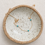 Dainty turquoise station necklace in 14k gold filled resting in a speckled ceramic dish