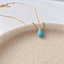 Close-up of the faceted turquoise briolette wire-wrapped to a gold filled chain - Lolabean