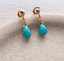 Close-up of hand wire-wrapped faceted turquoise briolettes on gold filled ball stud earrings