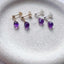 Close-up of Amethyst Stud Earrings in sterling silver with natural purple gemstones