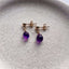 Close-up of Amethyst Stud Earrings in sterling silver with natural purple gemstones