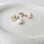 gold filled triangle stud earrings  with baby pink opal roundel drops are displayed on a stoneware jewelry dish