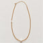 A delicate citrine beaded necklace featuring a single white freshwater pearl at the center and a small white mother of pearl star charm, displayed on a clean, light off-white background.