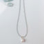 Long aquamarine beaded necklace with mother-of-pearl pendant and gemstone styling details