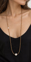 Model wearing long citrine beaded necklace with freshwater pearl