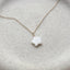 Close up of dainty 14k gold filled mother of pearl star charm necklace on ceramic dish