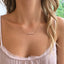 Pink opal beaded necklace worn with a lace-trim cami