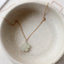 Dainty 14k gold filled prehnite blossom charm necklace on ceramic dish