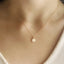 Mother of Pearl star charm necklace in gold filled shown on a model